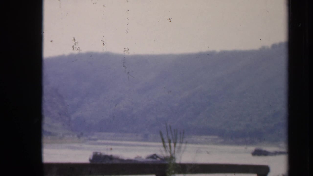 1949 Ireland home-movie view of a broad river and wooded hills framed by dark window mullions.