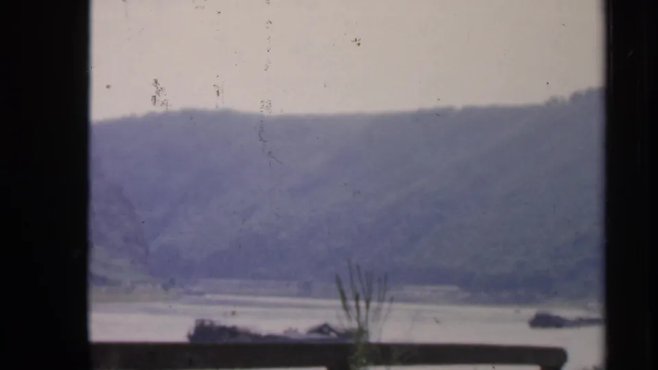 1949 Ireland home-movie view of a broad river and wooded hills framed by dark window mullions.