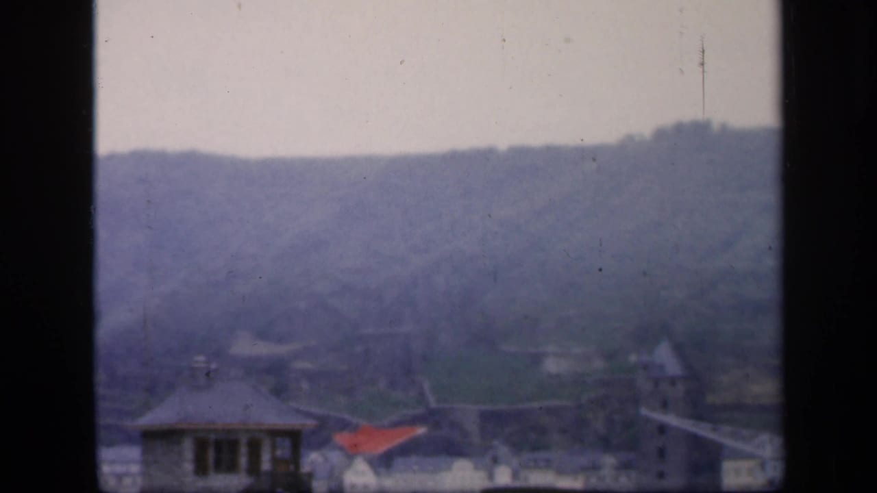 River valley and town rooftops seen through a window frame.