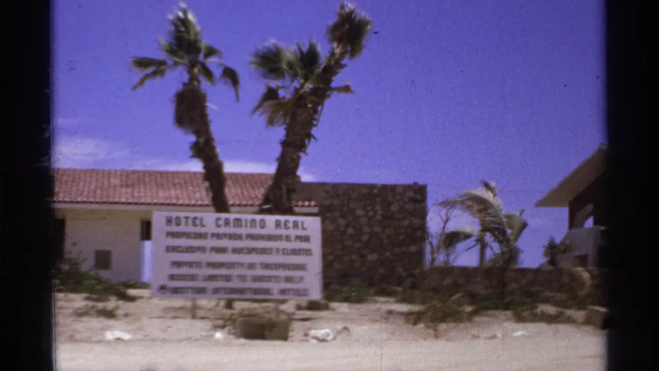 Hotel Camino Real sign remains visible near palms and resort buildings in 1970s Cabo San Lucas footage.