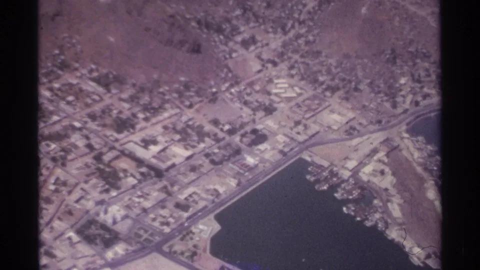 La Paz, Mexico, from the air in 1974, with harbor waters, shoreline roads, low buildings, docks, and surrounding dry landscape.