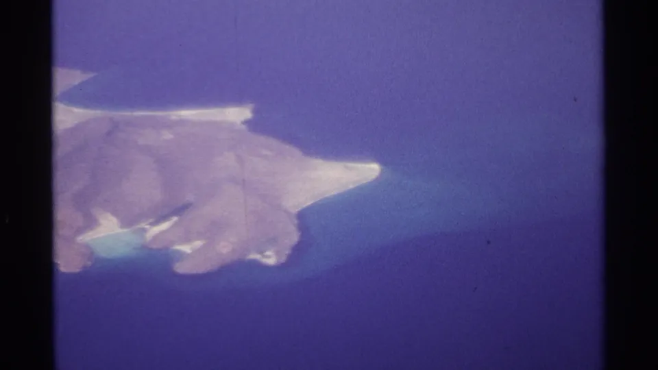 1974 8mm aerial view near La Paz, Mexico, showing an island with white beaches and turquoise shallows.