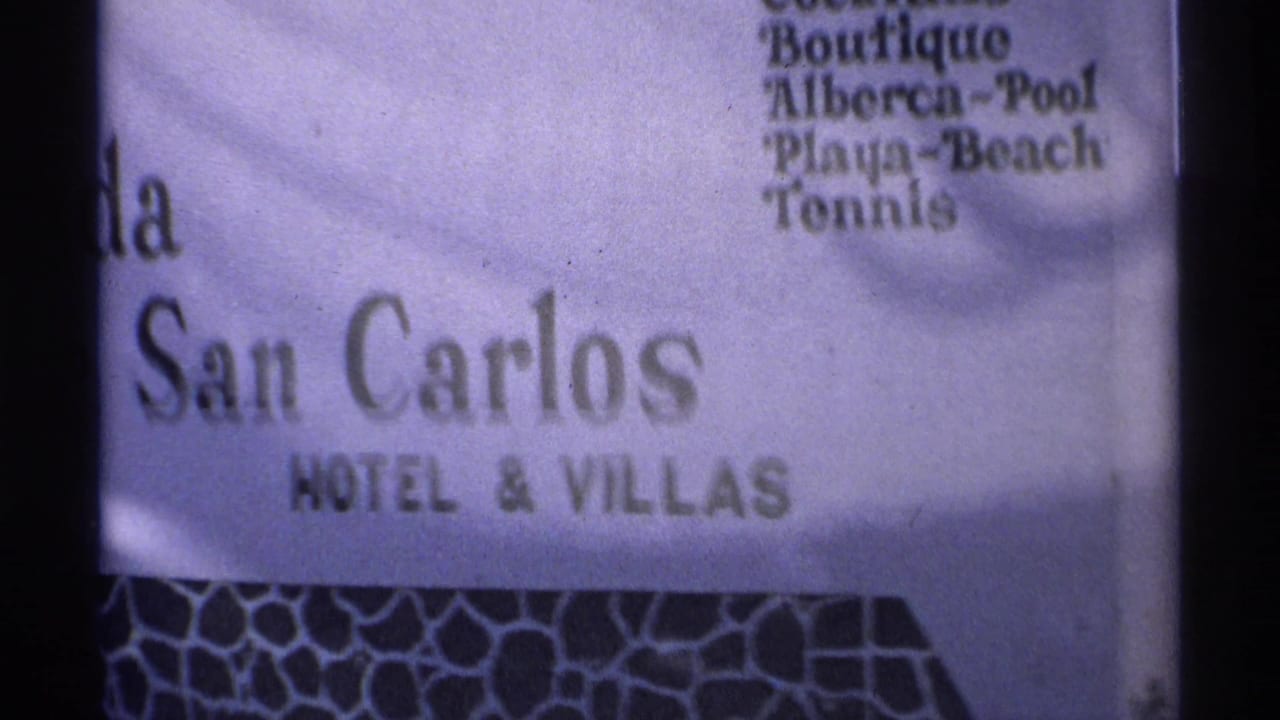 Closer view of the San Carlos Hotel and Villas sign and amenities list.