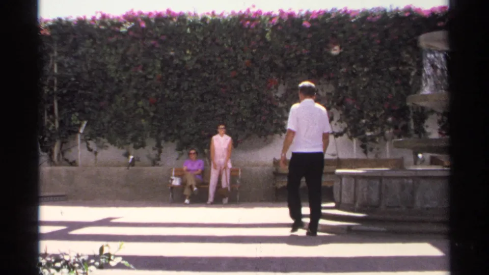 At the end of the Guaymas courtyard shot, one woman stands near the bench as the man approaches the fountain steps.