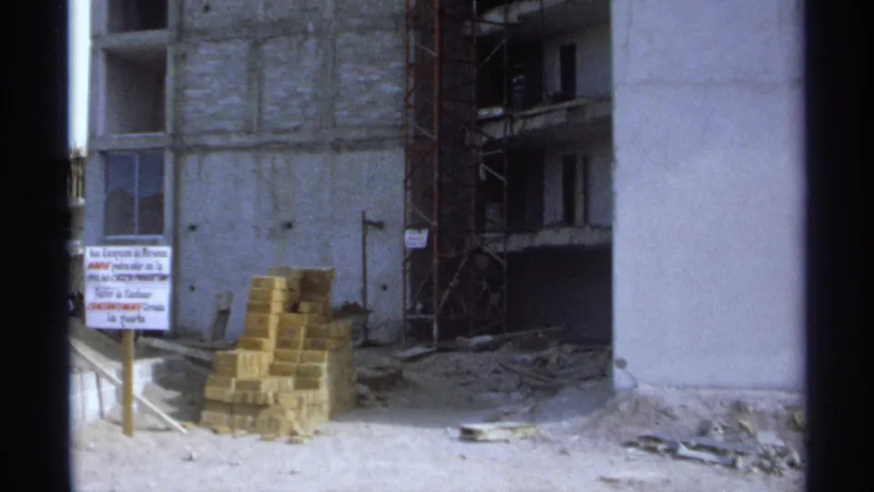 The final Guaymas frame shifts to a building under construction with scaffolding, stacked bricks, debris, and a visible sign.