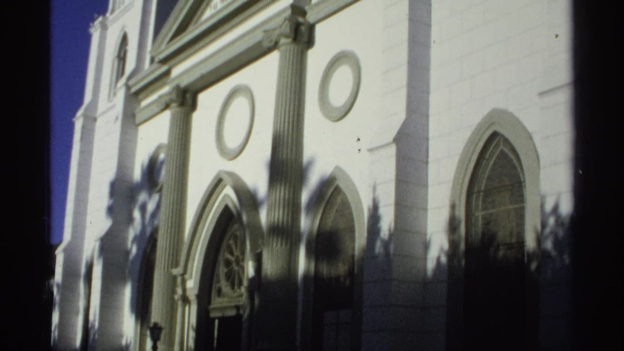 San Fernando Cathedral exterior in Guaymas, with paired columns, circular wall ornaments and arched windows visible in 8mm footage.