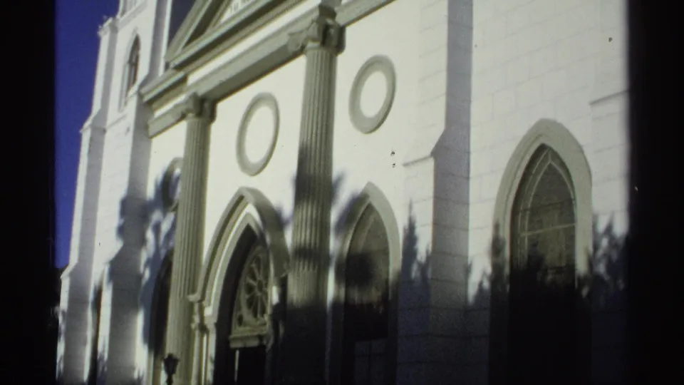 San Fernando Cathedral exterior in Guaymas, with paired columns, circular wall ornaments and arched windows visible in 8mm footage.
