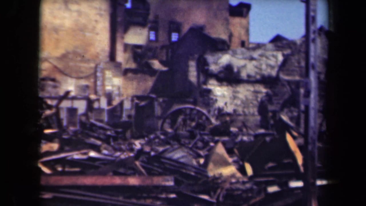 Rubble-filled urban ruins with damaged walls, beams, and a wagon wheel.