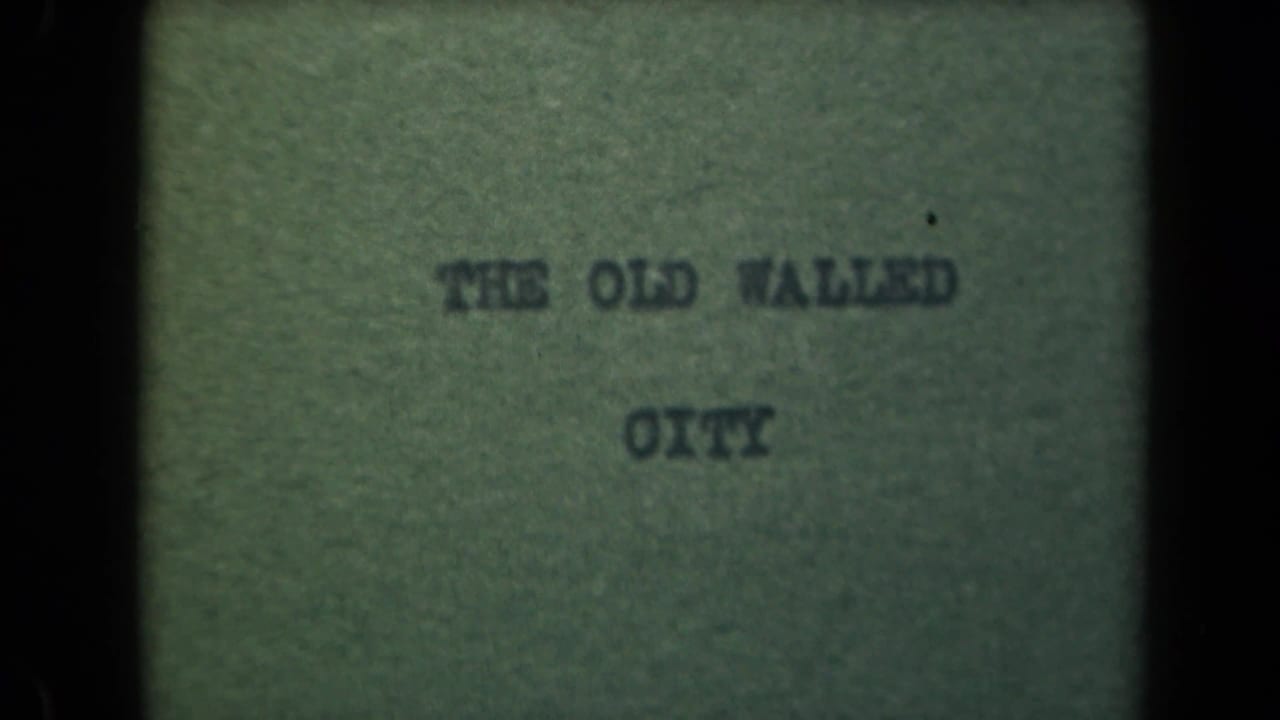 Second title card frame reading THE OLD WALLED CITY, with heavy dark borders and faded color.