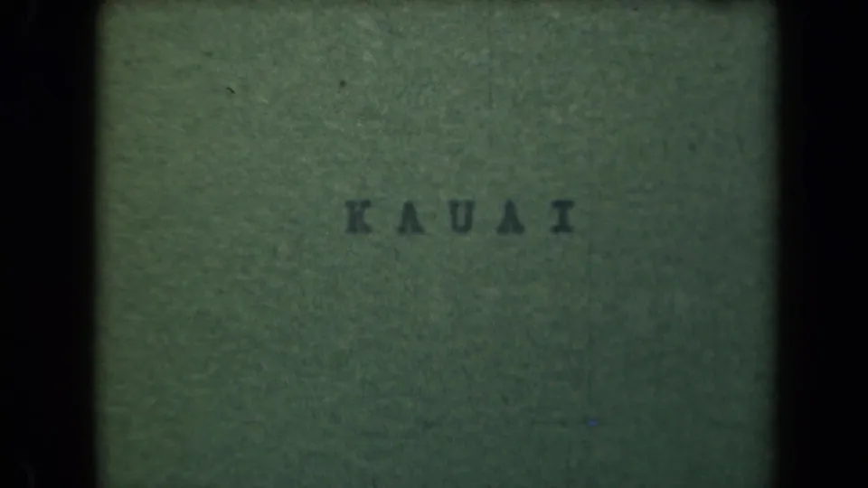 A second green 8mm title-card frame shows KAUAI in dark lettering with visible grain and gate edges.