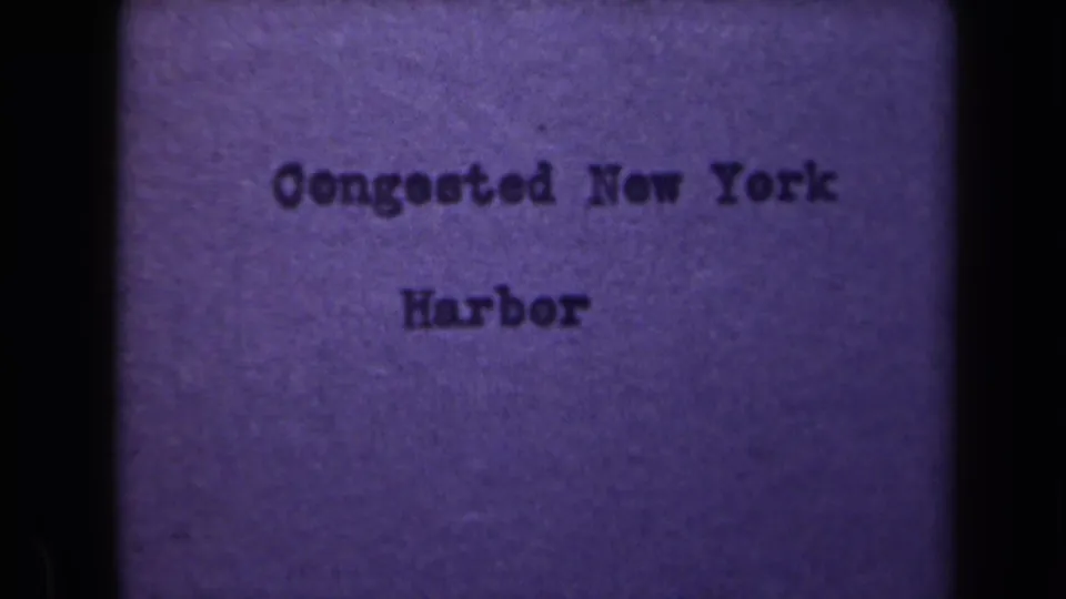New York Harbor title card remains on screen, with soft focus, grain, and dark frame-edge shadowing.