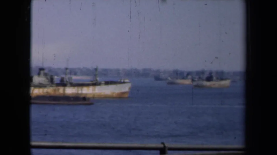 1946 New York harbor footage shows part of a weathered ship at left and smaller vessels farther out on the water.