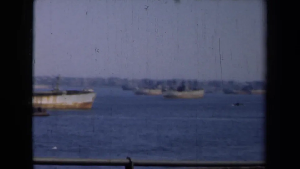 The final frame shows a partial weathered ship and distant harbor vessels in 1946 New York, viewed through dark foreground framing.