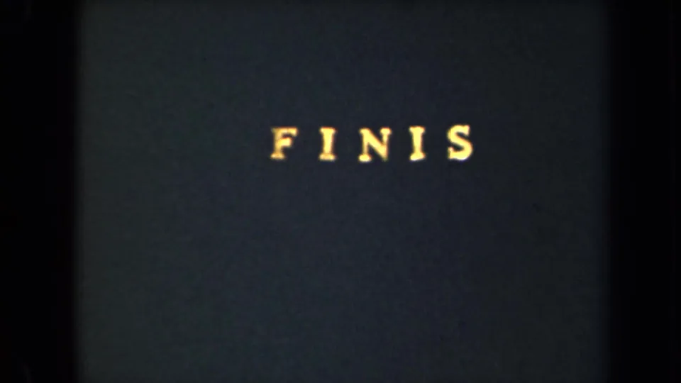 1946 8mm frame from New York showing yellow “FINIS” text centered on a dark title card.