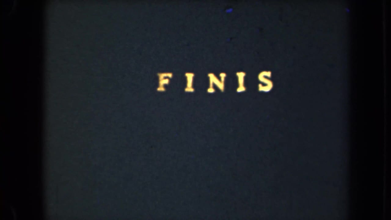 Yellow “FINIS” lettering near the top of a dark title card.