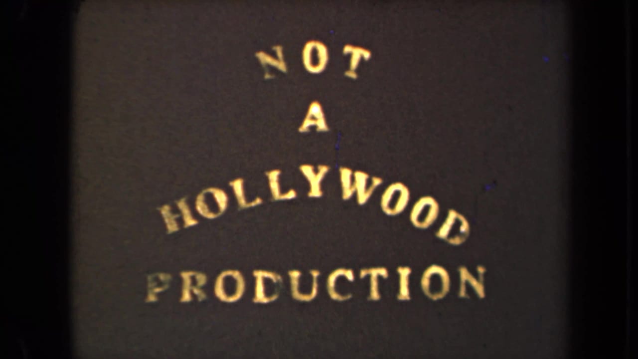 1946 8mm title card with gold arched lettering reading NOT A HOLLYWOOD PRODUCTION against a dark background.