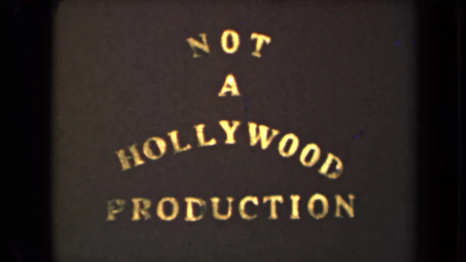 1946 8mm title card with gold arched lettering reading NOT A HOLLYWOOD PRODUCTION against a dark background.