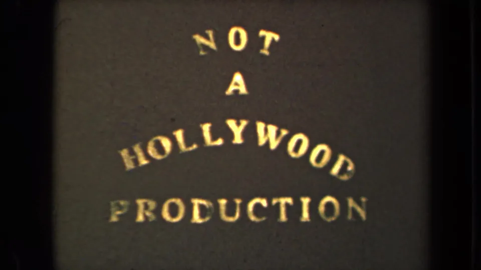 1946 8mm title-card frame with warm gold text, soft focus, and visible film grain.