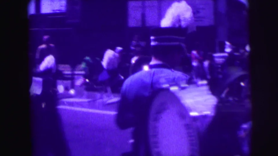The final frame shows a uniformed band member from behind with other marchers ahead in a purple-tinted street parade view.