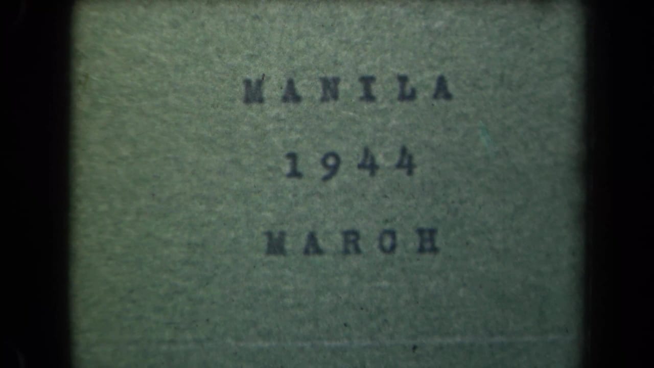 Green-tinted 8mm title card reading MANILA 1944 MARCH within dark film borders.