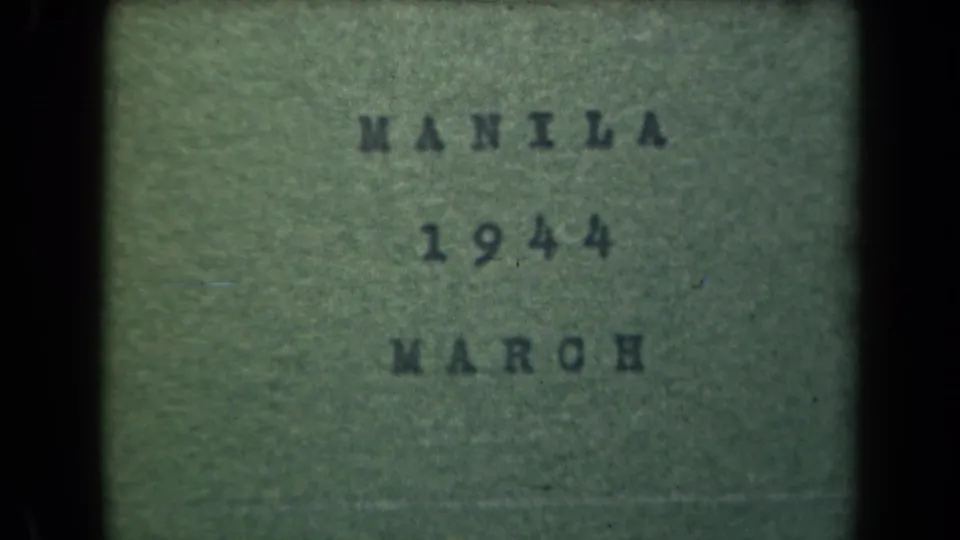 Manila, Philippines title-card frame dated 1944 and March, with visible 8mm grain, muted green tint, and black border at left.