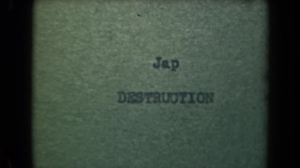 1944 Manila metadata-supported close-up of typed wording on paper, with dark film borders and soft 8mm grain.