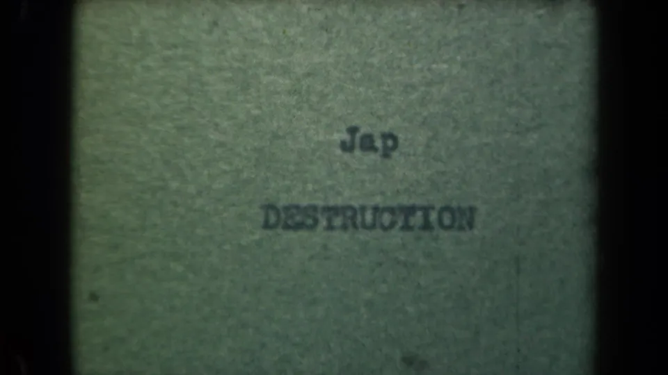 Close-up of the same typed wartime wording on paper, with slight blur, grain, and black film edges.