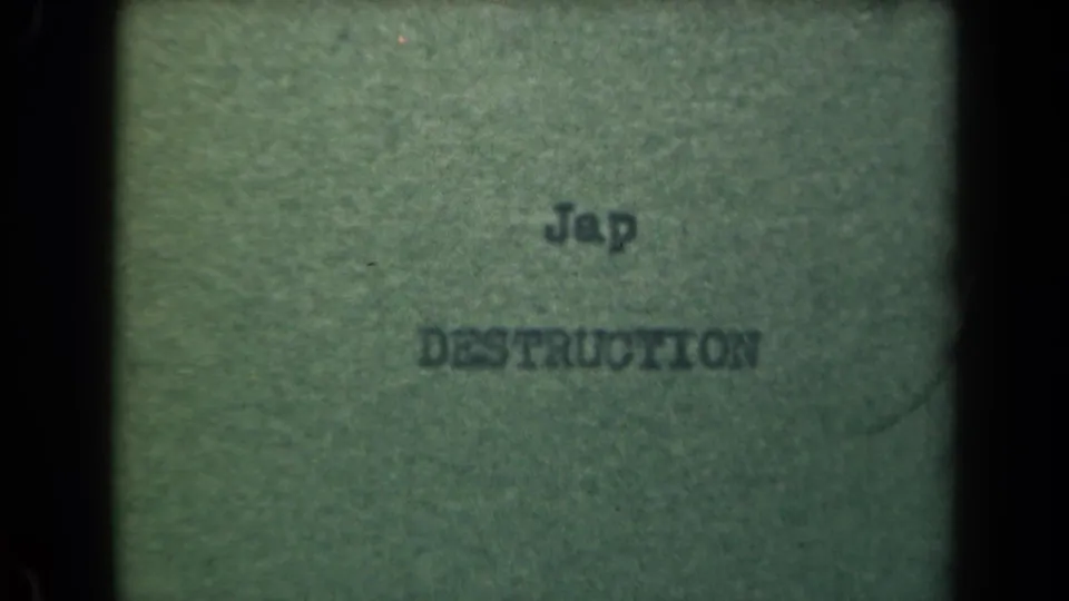 8mm close-up of typed text on paper, metadata linked to 1944 Manila, with soft focus and visible film texture.
