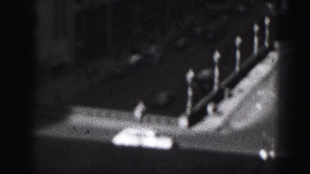 Blurred elevated view of a street edge or roofline with a row of globe lampposts.