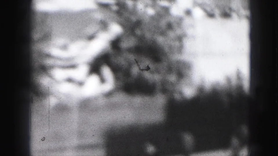1946 Harrisburg home-movie frame with indistinct people skating or standing near a rink, softened by grain and exposure haze.