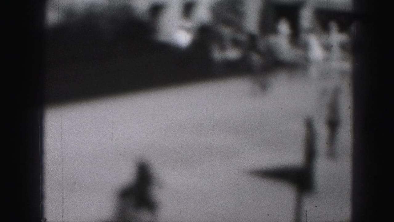 A blurred figure moves across open ice with people in the background.