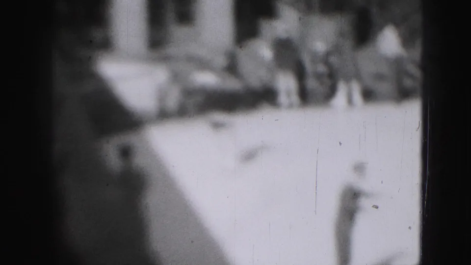 Soft-focus 1946 Harrisburg frame with skaters and onlookers gathered along an outdoor ice surface.