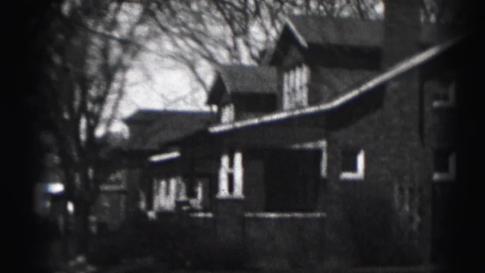 Harrisburg residential exterior, likely 1946, showing a two-story house with porch, gable, bare trees, and soft 8mm focus.
