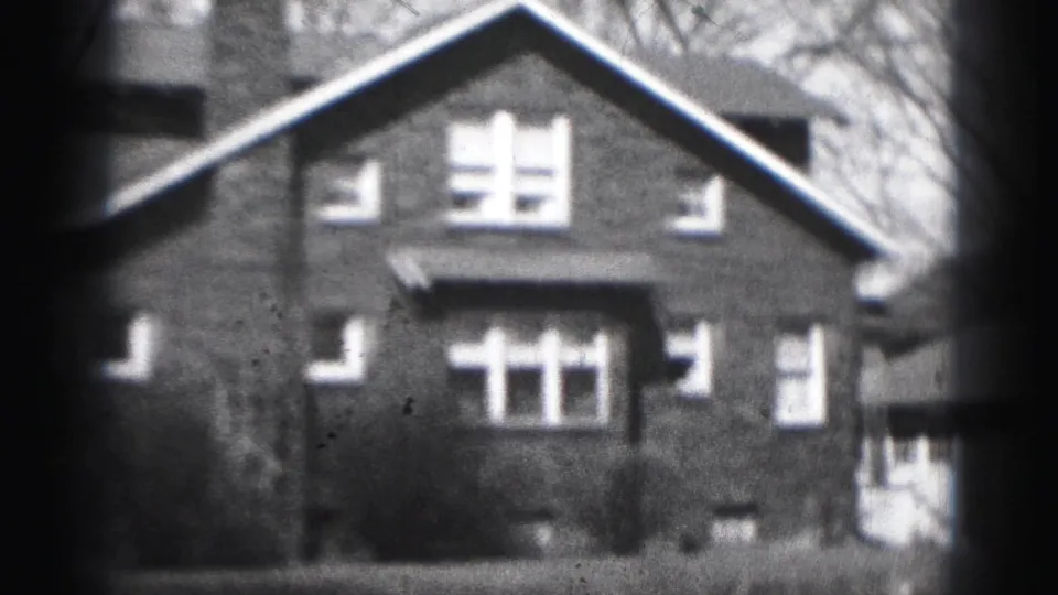 1946 Harrisburg street-view frame centering the brick residence, with multi-pane windows, shrubs, and part of a neighboring structure.