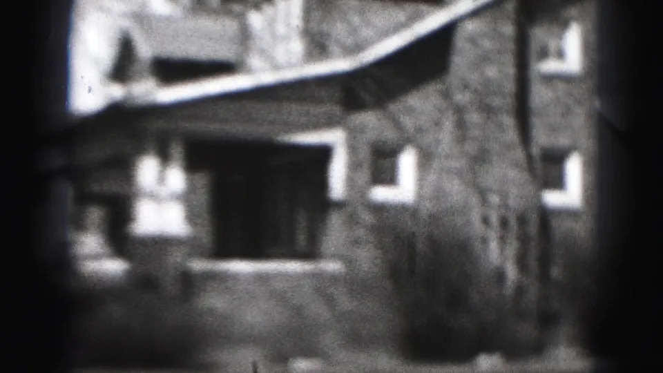 A 1946 Harrisburg house exterior appears from the street, showing a porch, windows, shrubs, and strong 8mm edge shadowing.