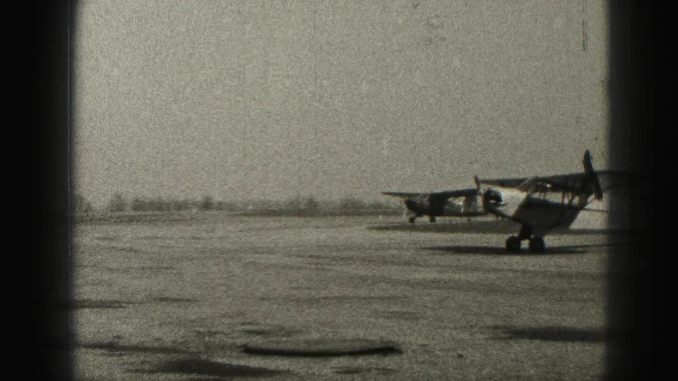 A small propeller plane sits or rolls on the runway, with another aircraft visible behind it in the 1946 Harrisburg footage.