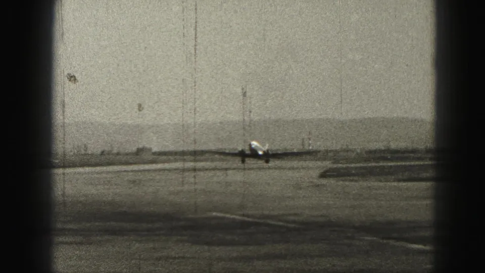 A twin-engine propeller airplane nears the runway at a Harrisburg, Pennsylvania air strip in 1946 home-movie footage.