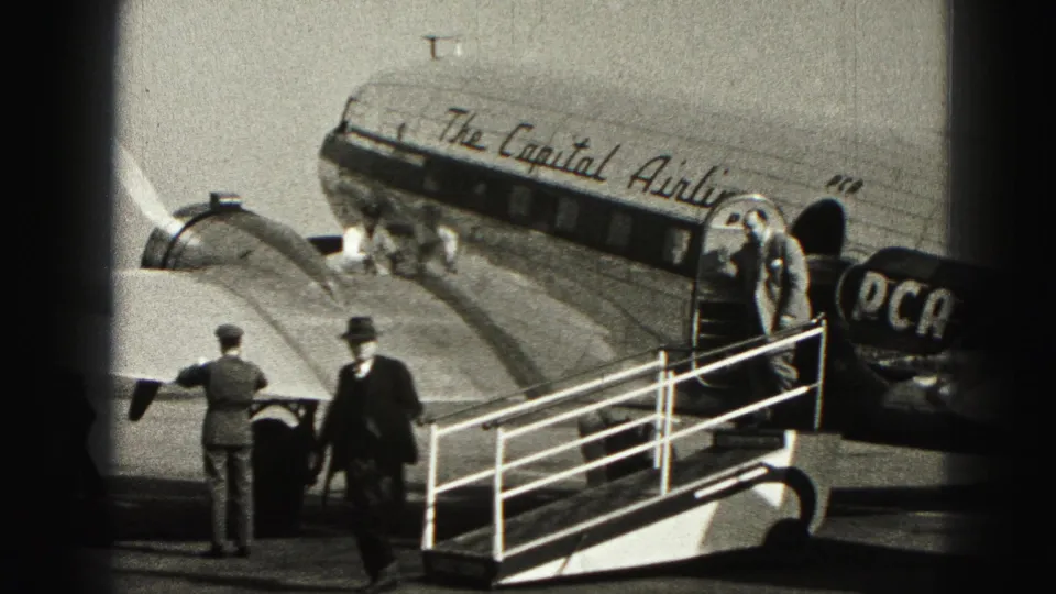 Passengers step down from a Capital Airlines aircraft while ground staff wait beside the mobile stairway in 1946 Harrisburg footage.