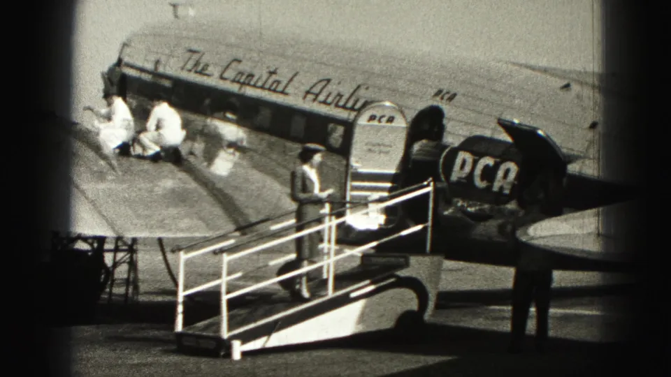Harrisburg 1946 view of a Capital Airlines DC-3 during boarding, with PCA marking and ramp personnel visible.