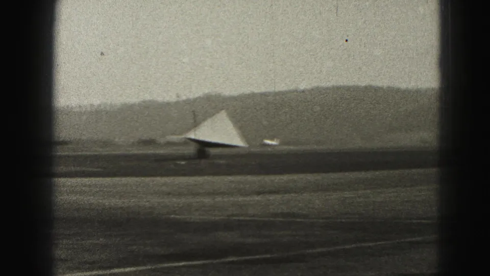 The 1946 Harrisburg airfield view shows a runway, low hills, and a triangular light-toned structure or aircraft surface in the distance.