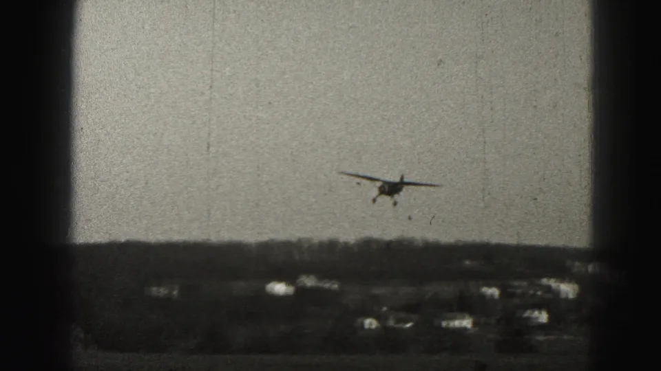 A small propeller plane appears lower over the horizon, with scattered houses below in the Harrisburg 1946 scene.