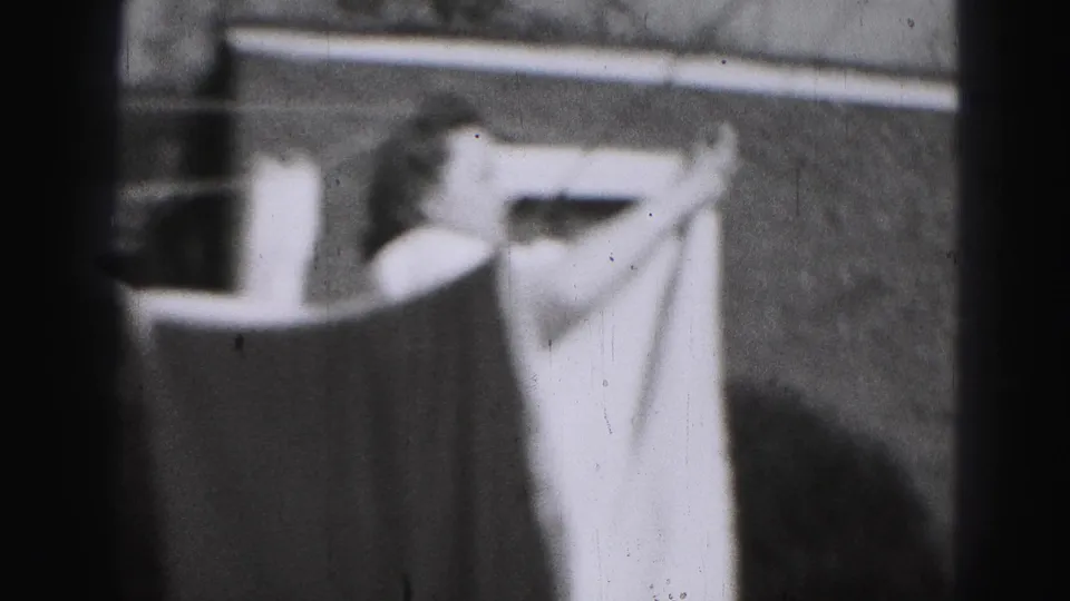 The closing frame shows a sheet on a clothesline outside a Harrisburg house, with the woman no longer clearly visible.