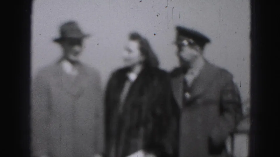 The final 1946 Harrisburg frame shows the trio in profile-like interaction after posing, with the peaked cap and fedora still visible.