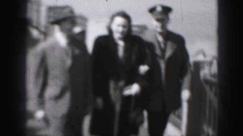 At the end of the 1946 Harrisburg clip, the officer and couple are close to the camera, still walking along the railed path.