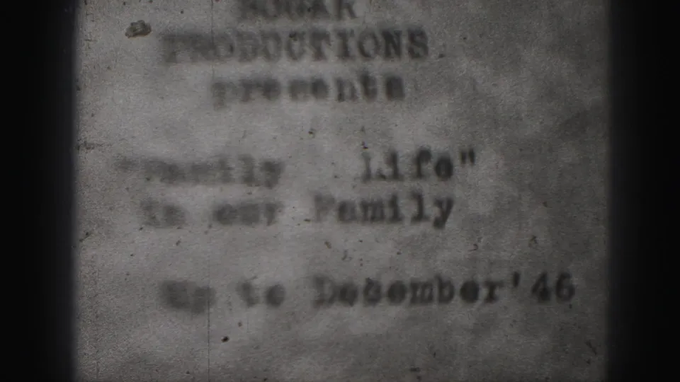 A 1946 Harrisburg family-film title card appears in soft focus, with typed text, a December date line, and a dark vertical gate shadow.