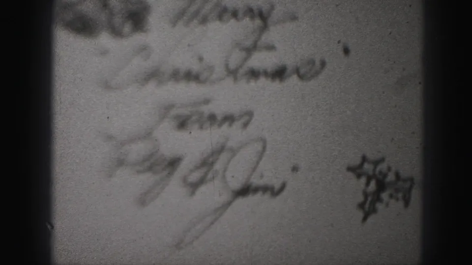 Handwritten Christmas greeting appears on the 1946 home-movie title sequence, with cursive lines, film grain, dust, and soft exposure.