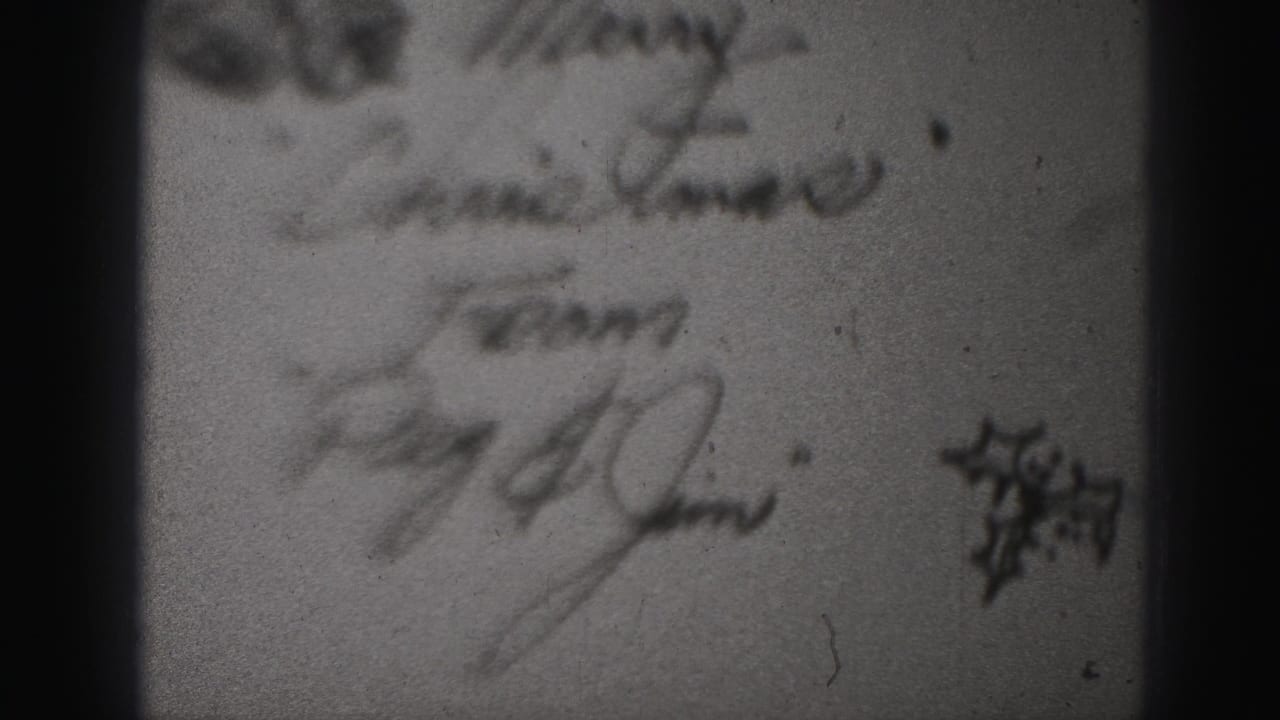 Soft close-up of handwritten notes and a small dark graphic on paper.