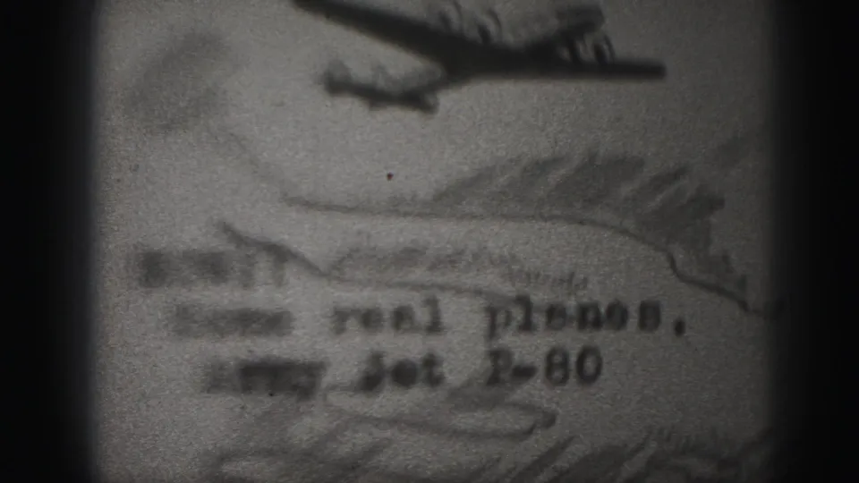 1946 Harrisburg 8mm frame showing a filmed plane picture with partial P-80-related lettering and heavy black-and-white grain.