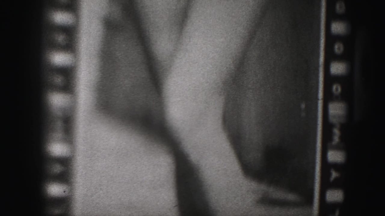1946 Harrisburg home-movie frame with a close cropped view of a woman's legs and torso in a fitted garment.