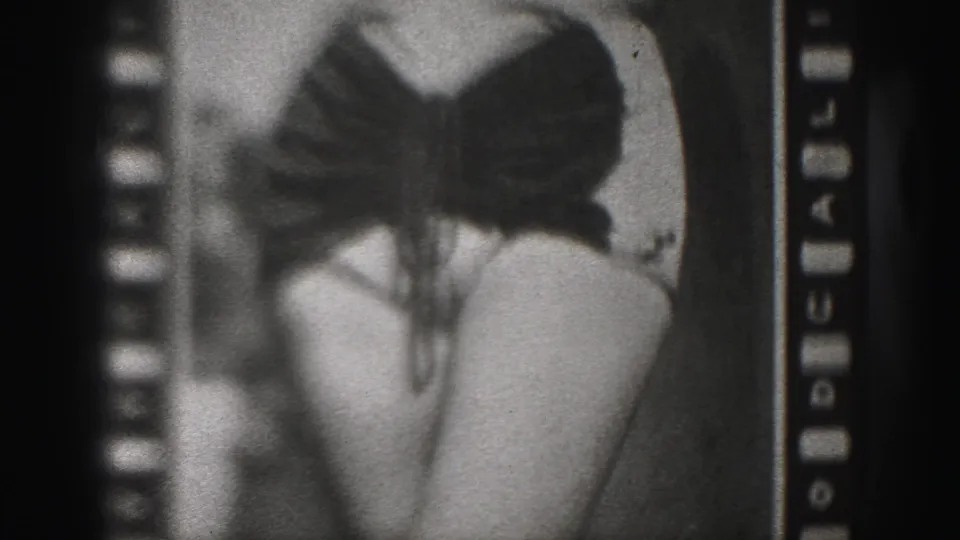 1946 Harrisburg 8mm frame with the woman centered lower in the contact sheet, emphasizing the dark swimsuit and legs in soft focus.